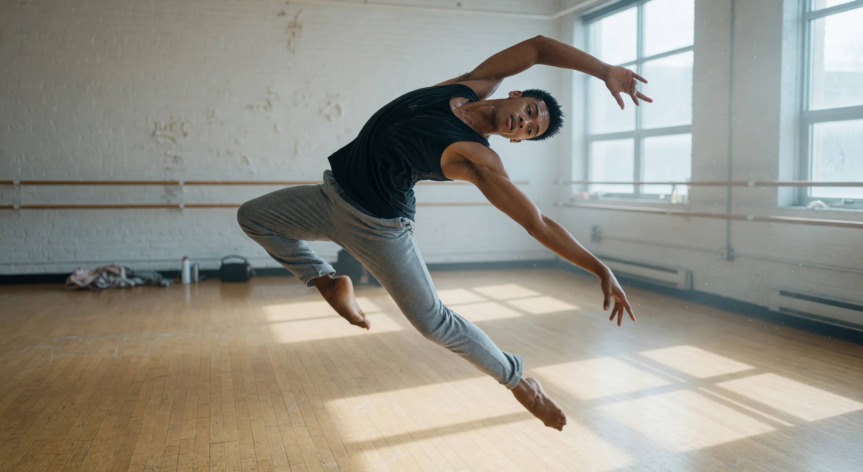 A dancer in midair in a bright studio, creative inspiration